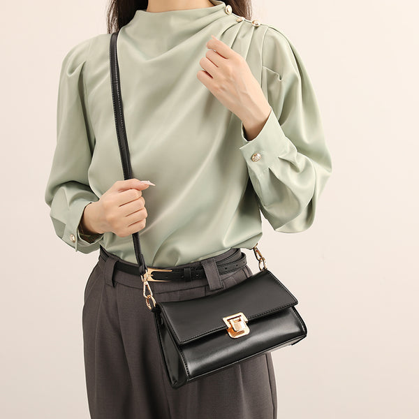 Black shoulder bag with gold-colored buckle – compact and chic