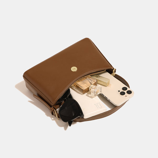 Brown shoulder bag with gold-colored chain and buckle detail